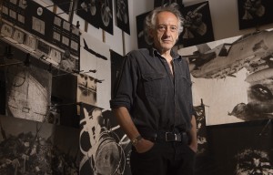 Peter Kennard in his installation The Boardroom, part of Peter Kennard: Unofficial War Artist, at Imperial War Museum London.