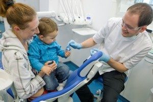 Trainee dentist with parent and child