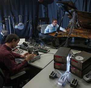 Photo 3: Edward Braund (on the microscope) and the author (on the piano) testing the interactivemusical biocomputer in the ICCMR studio.