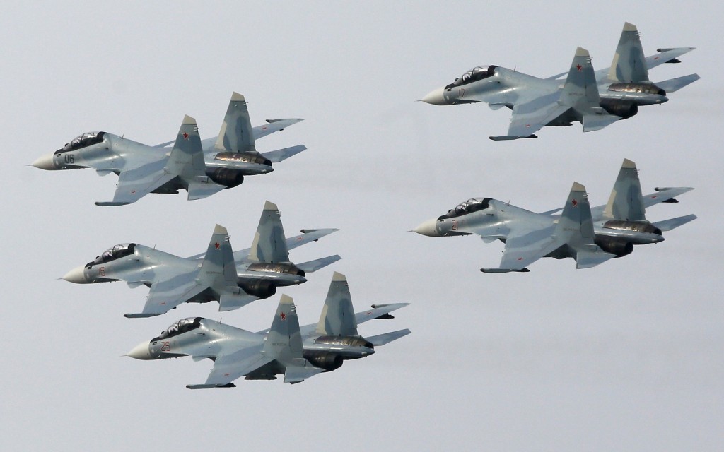 Jet fighters from the Su-30 SM "Sokoly Rossii" (Falcons of Russia) aerobatic team fly in formation during the show in Krasnoyarsk, Siberia, October 25, 2014. The show is conducted as part of a recruitment drive for Russia's military divisions, targeting the youth towards contractual military service, according to organizers. REUTERS/Ilya Naymushin (RUSSIA - Tags: MILITARY SOCIETY TRANSPORT) - RTR4BK9G