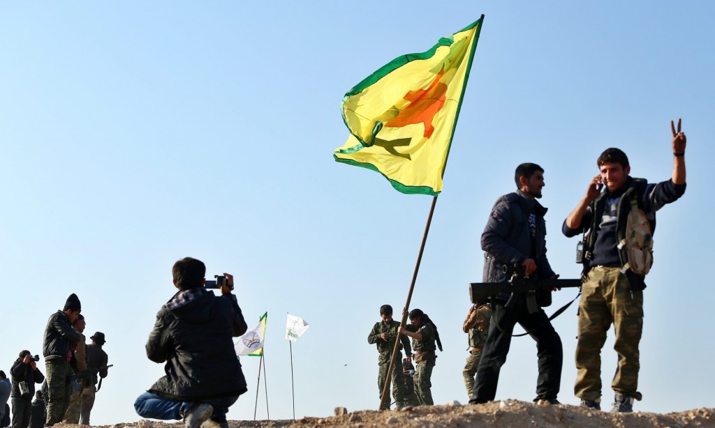epa04586503 Members of the Syrian Kurdish People's Defence Units (YPG) celebrate their victory in Kobane, Syria, 26 January 2015. According to reports Kurdish fighters claim to have pushed militants from the group calling themselves Islamic State (IS) out of the whole of Kobane following four months of fighting, supported by airstrikes carried out by an international anti-IS coalition, though a number of the town's surrounding villages, close to the Syrian-Turkish border, remain in the hands of IS.  EPA/STR