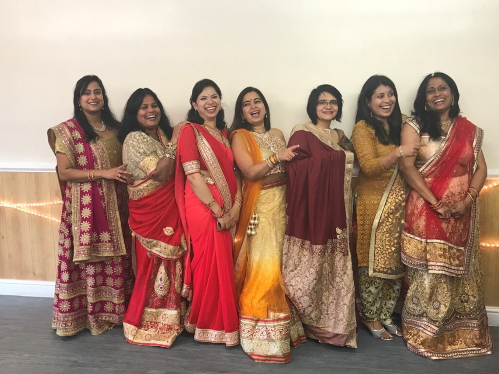 Seven staff members in their traditional attire to celebrate Diwali.