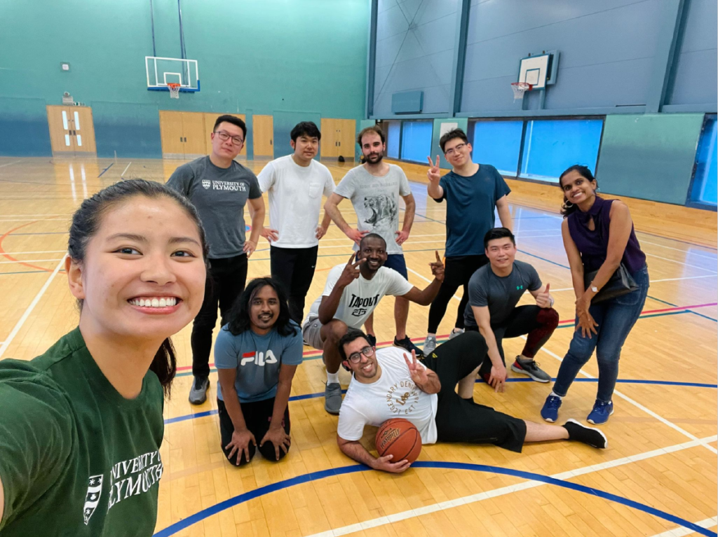 Attendees of the Plymouth Business School Free Sports Programme gathered to take a selfie in a sports hall, after playing a game of basketball.